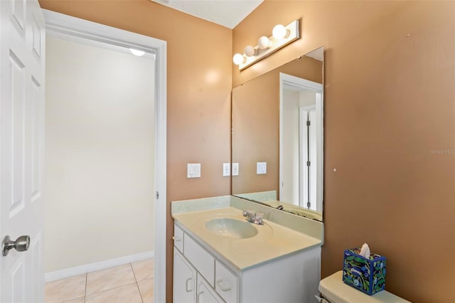 bathroom with tile patterned flooring, toilet, and vanity