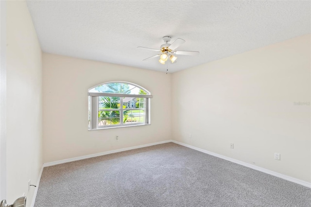 carpeted spare room with ceiling fan and a textured ceiling