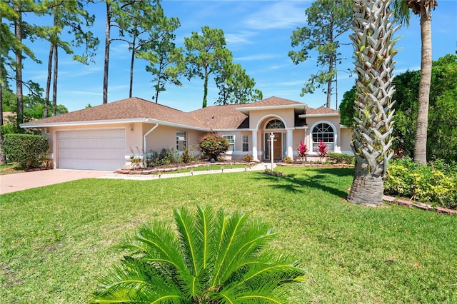 view of front of house featuring a garage and a front yard