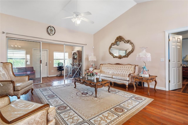 living room with lofted ceiling, ceiling fan, and wood-type flooring