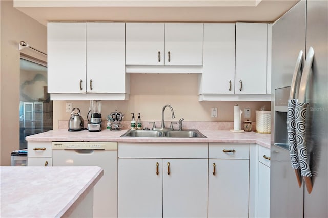 kitchen with stainless steel fridge with ice dispenser, white cabinetry, and sink