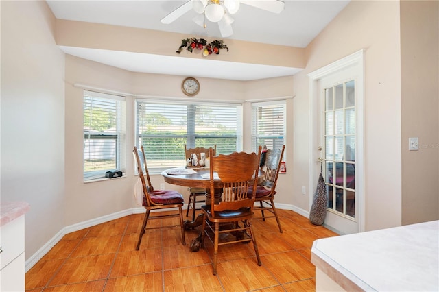 dining area with light hardwood / wood-style flooring, ceiling fan, and vaulted ceiling