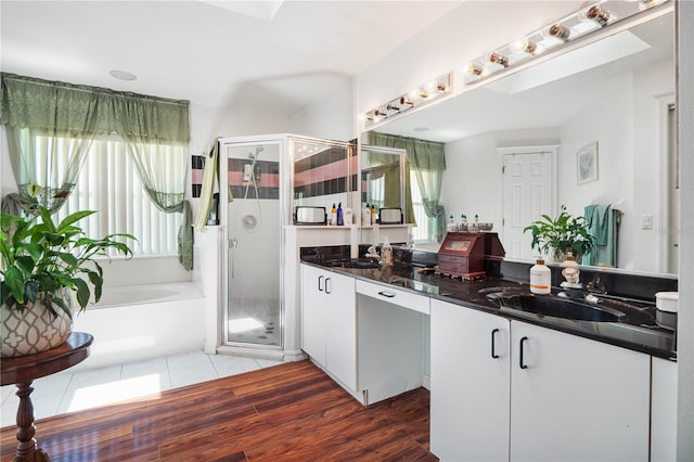 bathroom with vanity, independent shower and bath, and hardwood / wood-style flooring