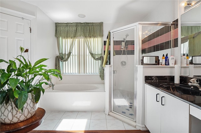 bathroom featuring vanity and shower with separate bathtub