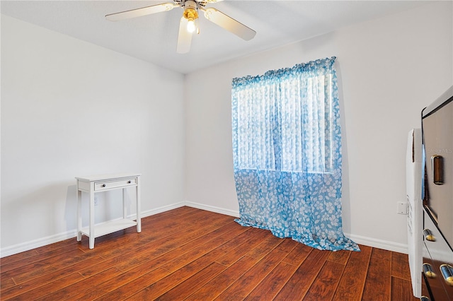 unfurnished room with ceiling fan and dark hardwood / wood-style floors