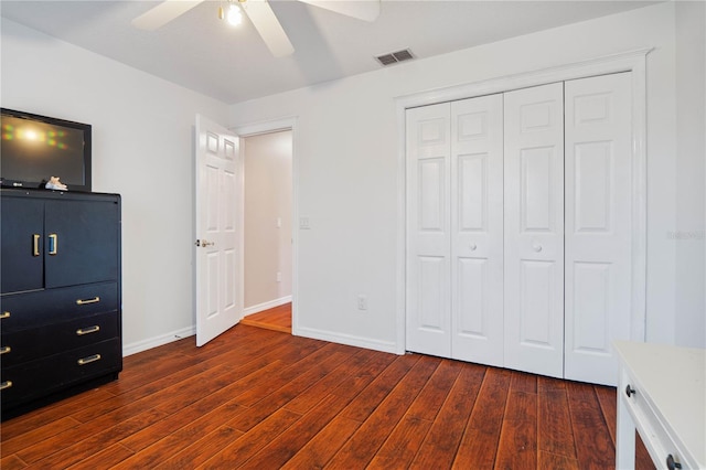 unfurnished bedroom with a closet, ceiling fan, and dark hardwood / wood-style floors