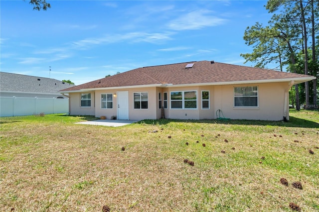 back of house featuring a yard and a patio area