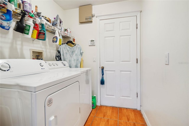 laundry room with separate washer and dryer and light hardwood / wood-style flooring