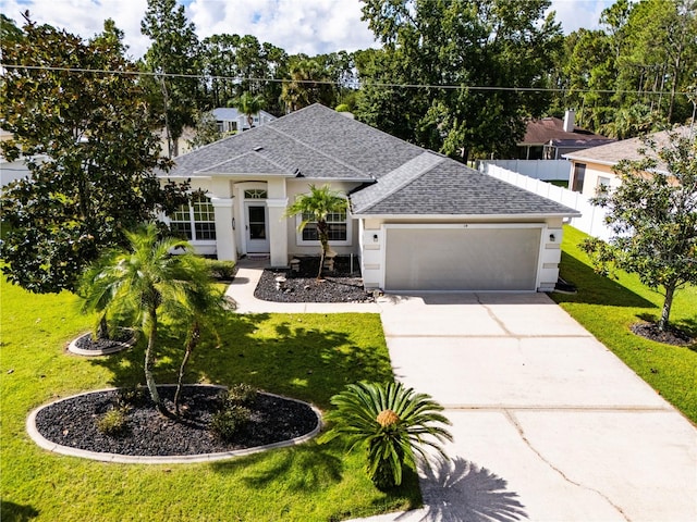 view of front of property with a garage and a front lawn