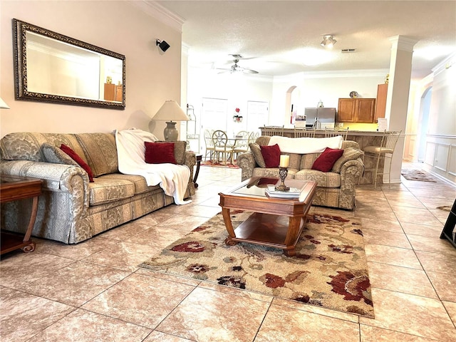 living room with a textured ceiling, ceiling fan, crown molding, and light tile patterned flooring