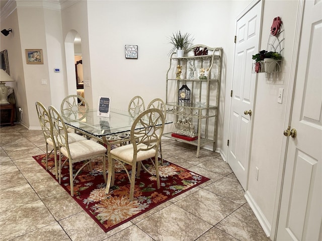 tiled dining area featuring ornamental molding