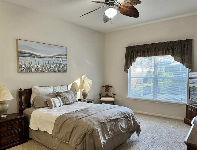 bedroom featuring ceiling fan and light carpet