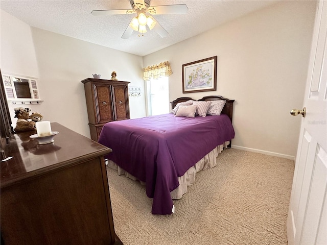 bedroom with a textured ceiling, ceiling fan, and light carpet