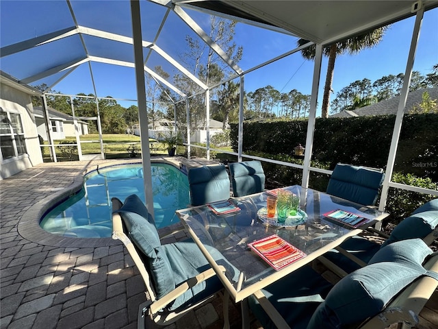 exterior space with glass enclosure and a patio