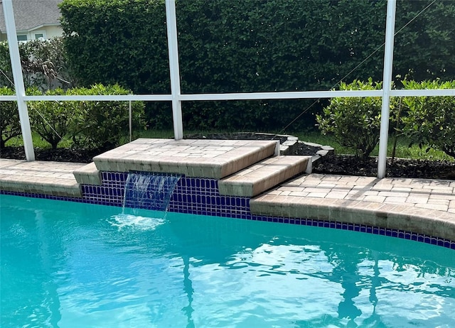 view of swimming pool featuring pool water feature