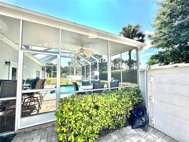 view of patio featuring outdoor lounge area and glass enclosure