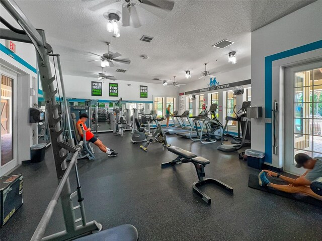 gym with a textured ceiling and ceiling fan