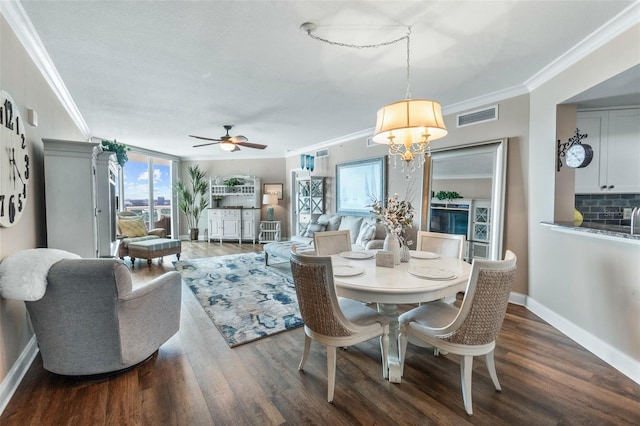 dining room featuring ceiling fan, ornamental molding, and wood-type flooring