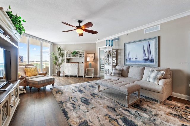 living room with ceiling fan, ornamental molding, hardwood / wood-style flooring, a textured ceiling, and expansive windows