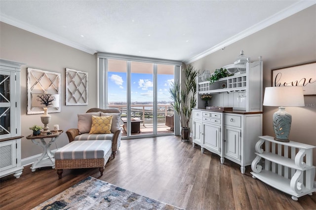 sitting room with wood-type flooring, ornamental molding, a textured ceiling, and floor to ceiling windows