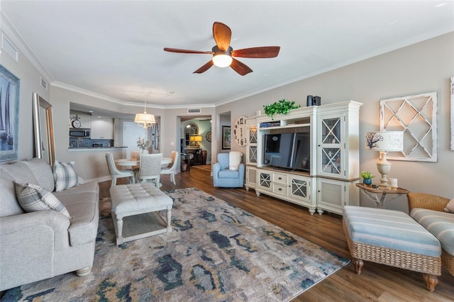 living room with ceiling fan, hardwood / wood-style flooring, and ornamental molding