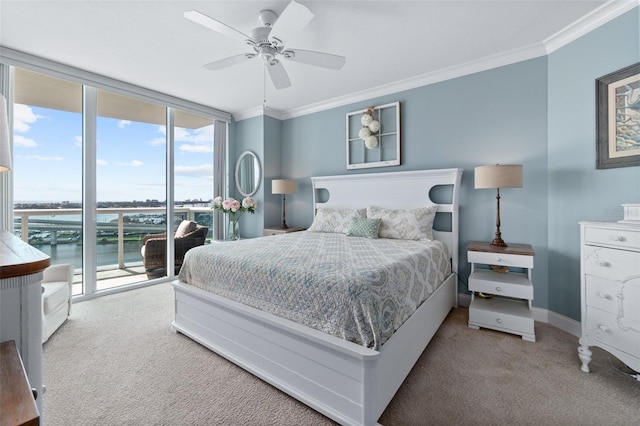 carpeted bedroom featuring ceiling fan, a water view, access to exterior, and crown molding