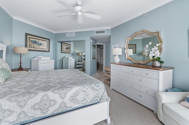 carpeted bedroom featuring ceiling fan, a closet, and ornamental molding