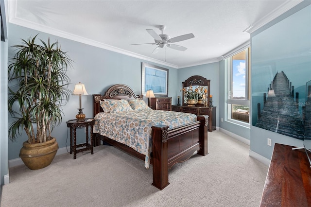 carpeted bedroom featuring ceiling fan and crown molding