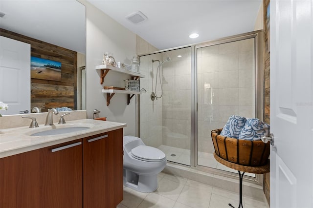 bathroom with an enclosed shower, toilet, vanity, and tile patterned floors