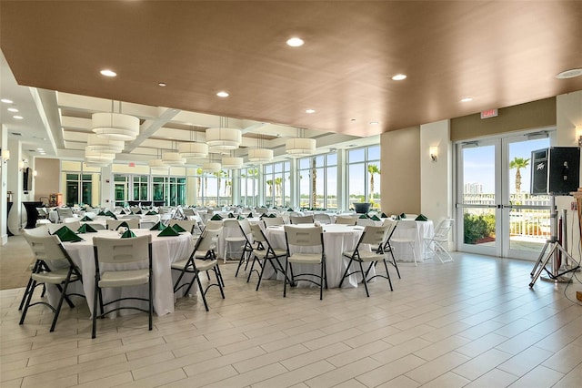 dining space with french doors and light tile patterned floors