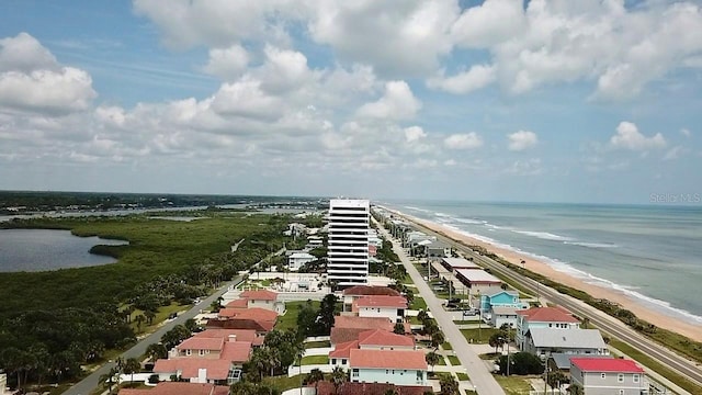 aerial view featuring a water view, a residential view, and a beach view