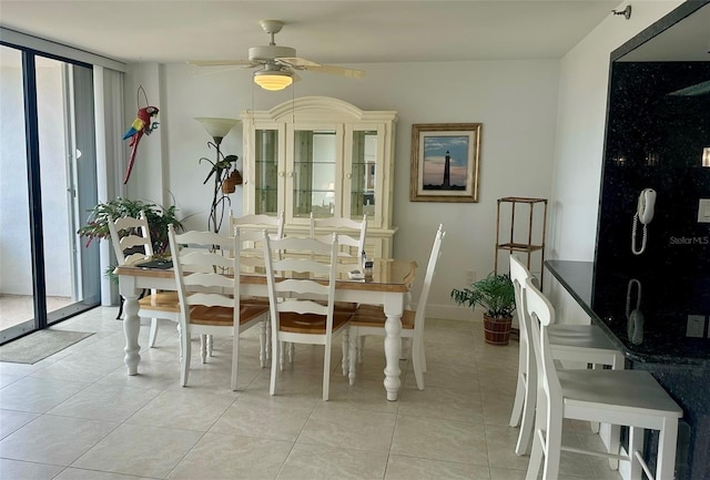 dining room with expansive windows, plenty of natural light, and light tile patterned flooring