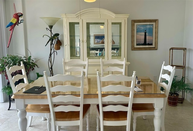 dining room with light tile patterned floors and baseboards