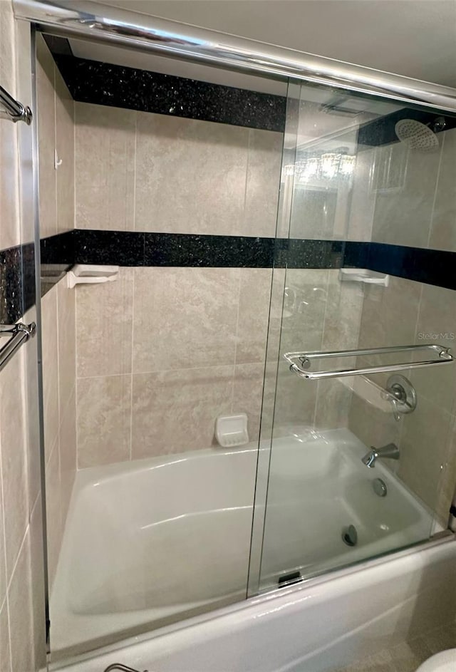 full bathroom with shower / bath combination with glass door