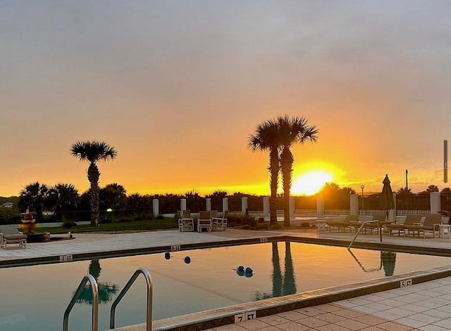 view of pool at dusk