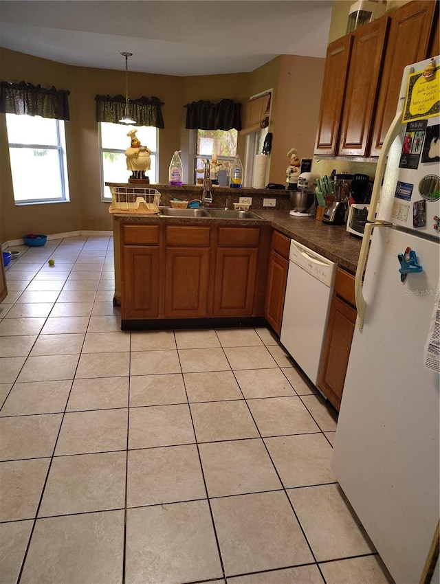 kitchen featuring sink, hanging light fixtures, kitchen peninsula, white appliances, and light tile patterned floors