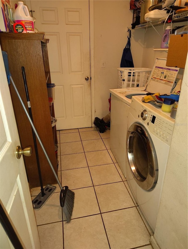 laundry room featuring light tile patterned floors and separate washer and dryer