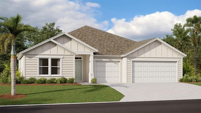 view of front of house with a garage and a front lawn