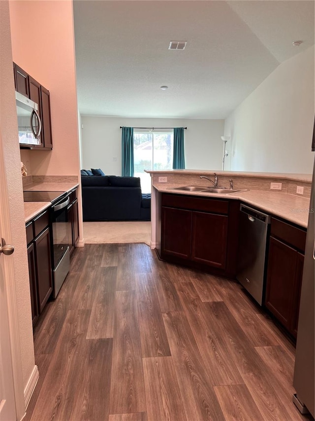 kitchen with dark brown cabinetry, stainless steel appliances, sink, and dark hardwood / wood-style flooring