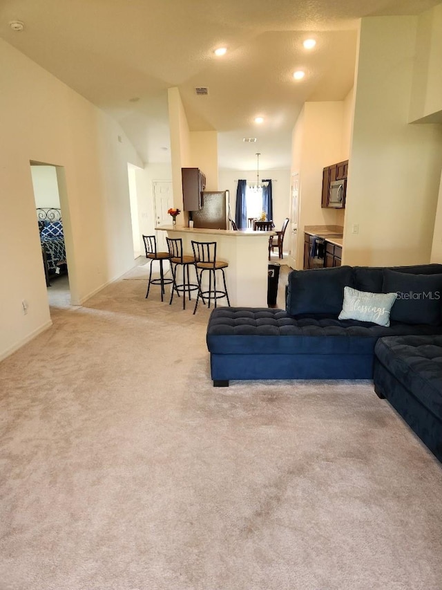 carpeted living room with vaulted ceiling