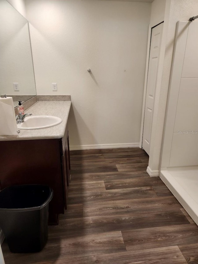 bathroom with vanity and wood-type flooring