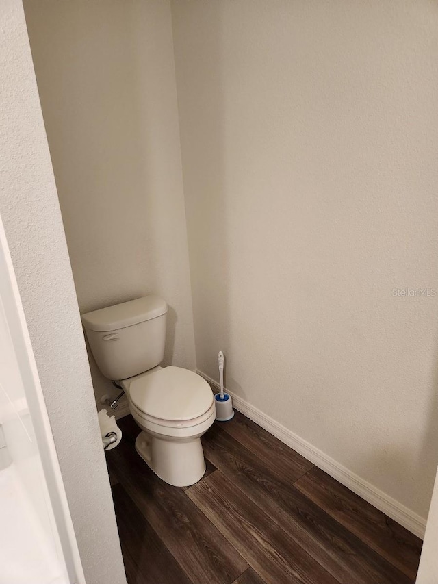 bathroom with toilet and hardwood / wood-style floors