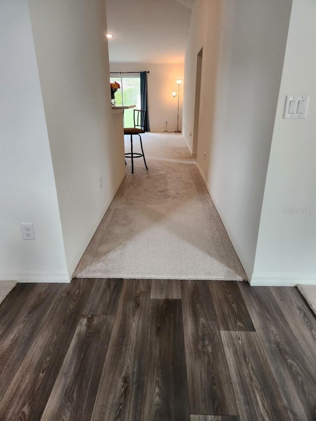 hallway featuring dark wood-type flooring