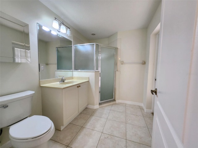 bathroom with tile patterned floors, vanity, toilet, and a shower with door