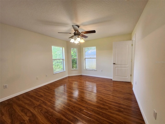 unfurnished room with a textured ceiling, dark hardwood / wood-style floors, and ceiling fan