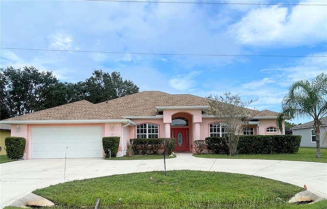 23 Flemington Ln, Palm Coast, FL 32137 - single story home featuring curved driveway, a front lawn, stucco siding, and an attached garage