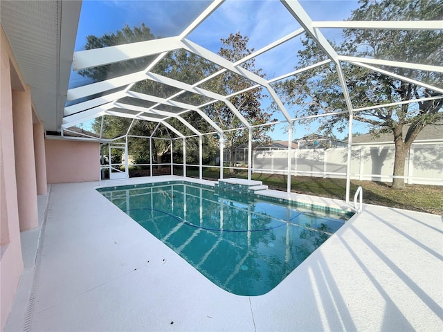 view of pool featuring a patio area and glass enclosure