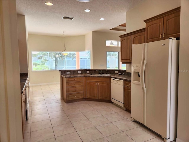 23 Flemington Ln, Palm Coast, FL 32137 - kitchen featuring white appliances, a sink, a textured ceiling, a peninsula, and recessed lighting