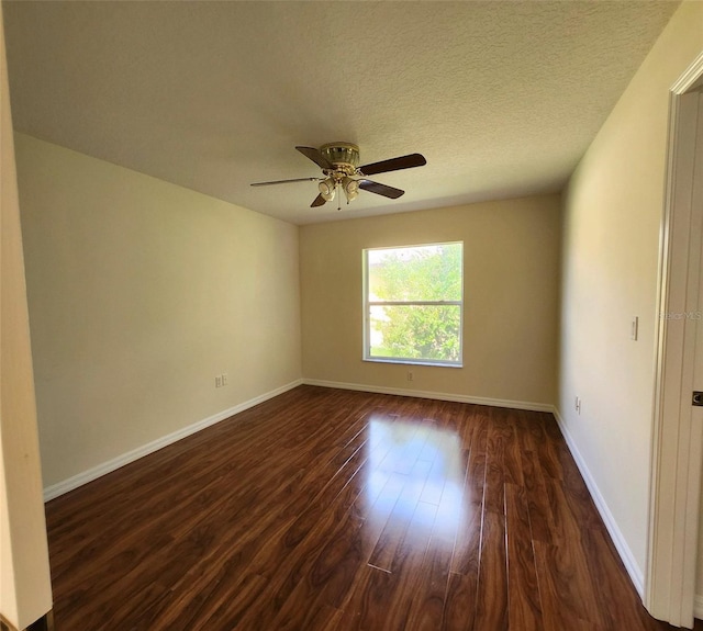 unfurnished room with a textured ceiling, ceiling fan, and dark wood-type flooring