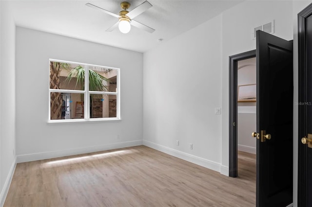 unfurnished room featuring light wood-type flooring and ceiling fan